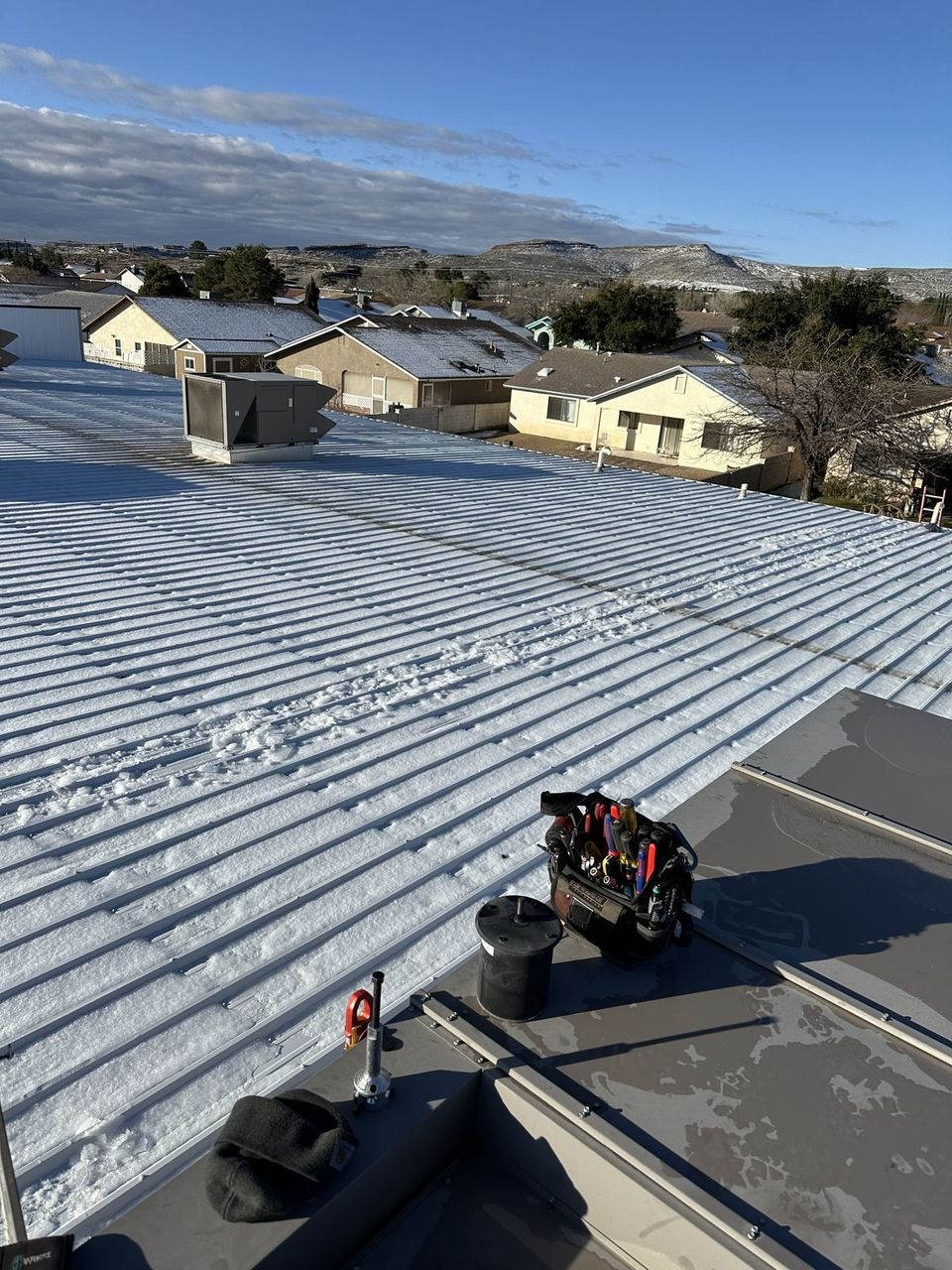 Snow on rooftops and mountains in northern Arizona where Air-Exx services heating systems